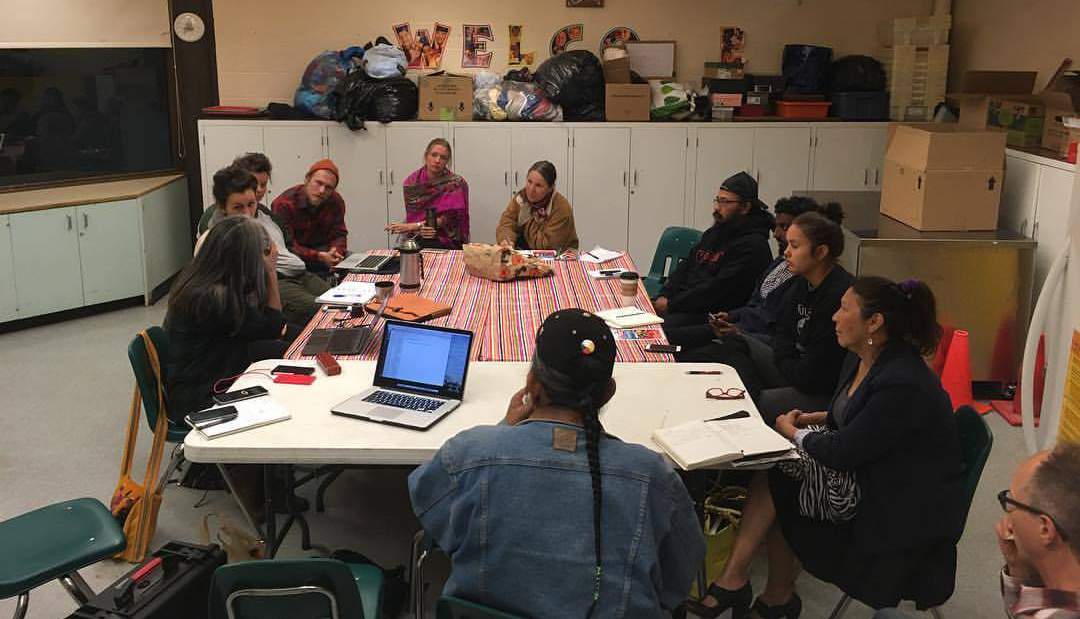 Wild Salmon Caravan planning team session in progress. Team sitting around a table.